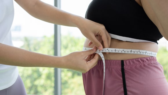 Lady getting her torso measured